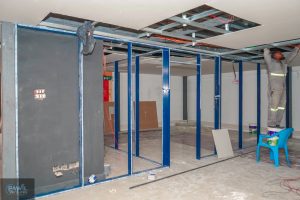 Steel partition framework and ceiling panel installation inside the Hazina Trade Centre shop fit-out.