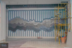 Decorative feature wall with a patterned design inside the commercial interior at Hazina Trade Centre.